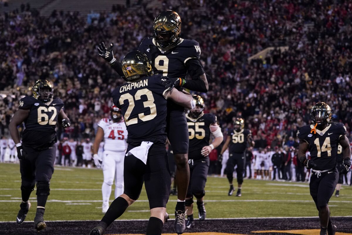 Wake Forest tight end Brandon Chapman celebrates after scoring with wide receiver A.T. Perry during the second half of an NCAA college football game against North Carolina State Saturday, Nov. 13, 2021, in Winston-Salem, N.C. (AP Photo/Chris Carlson)