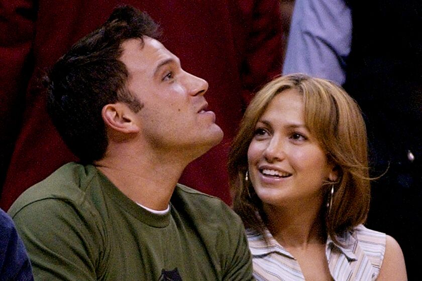 Actors Ben Affleck and Jennifer Lopez sit together at the Los Angeles Lakers' game against the San Antonio Spurs during at the Western Conference Semi-Finals game, Saturday night, May 11, 2003, in Los Angeles. The Lakers won the game 99-95 to tie the series at 2-2. (AP Photo/Mark J. Terrill)
