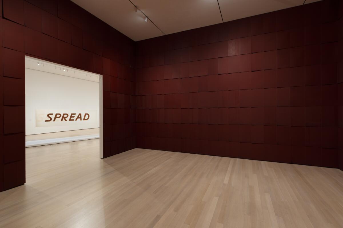 "Spread," a word-drawing made with tobacco juice, is glimpsed through the door from Ed Ruscha's "Chocolate Room."