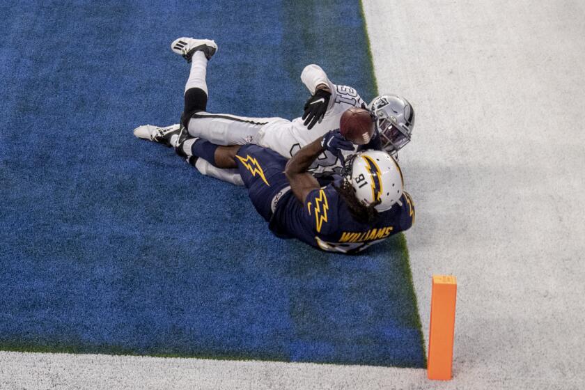 INGLEWOOD, CA - NOVEMBER 8, 2020: With 5 seconds left in the game, Los Angeles Chargers wide receiver Mike Williams (81) seems to catch the winning touchdown in the end zone against Las Vegas Raiders cornerback Isaiah Johnson (31), but the ball comes loose when he hits the ground and he was injured on the play at SoFi Stadium on November 8, 2020 in Inglewood, CA.(Gina Ferazzi / Los Angeles Times)