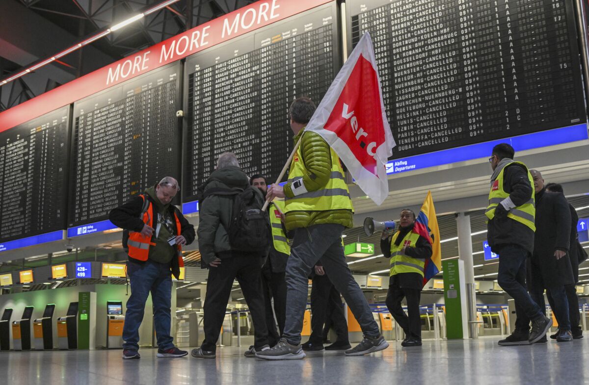 Striking airport employees inside German airport terminal
