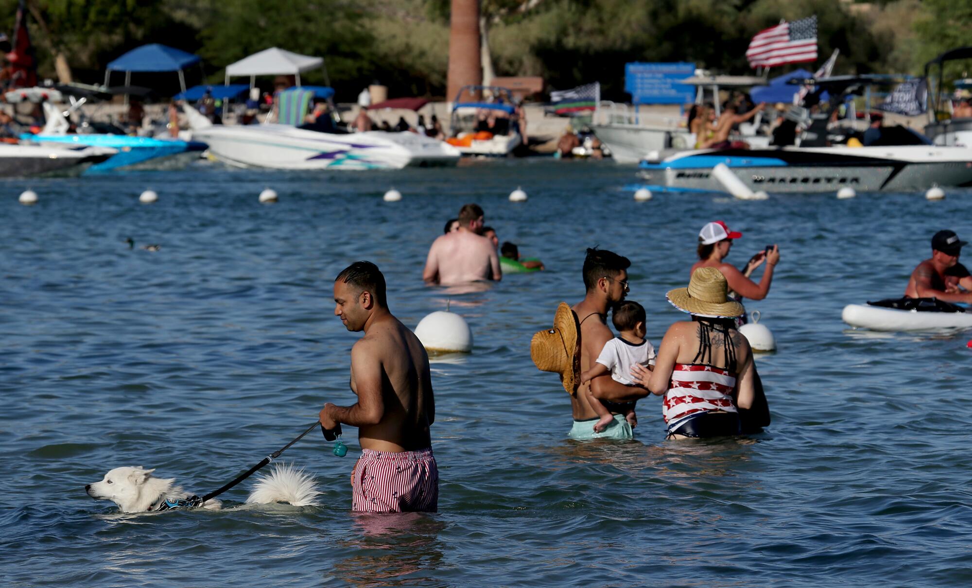 Swimmers take a dip in Lake Havasu during a holiday weekend. About a million people visit the lake each year.