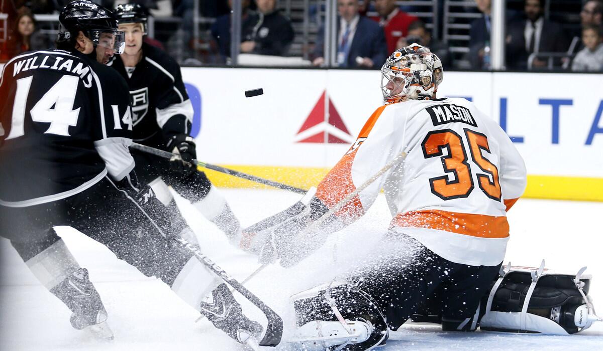 Flyers goalie Steve Mason (35) deflects a shot by Kings right wing Justin Williams (14) in the second period of their game Saturday.