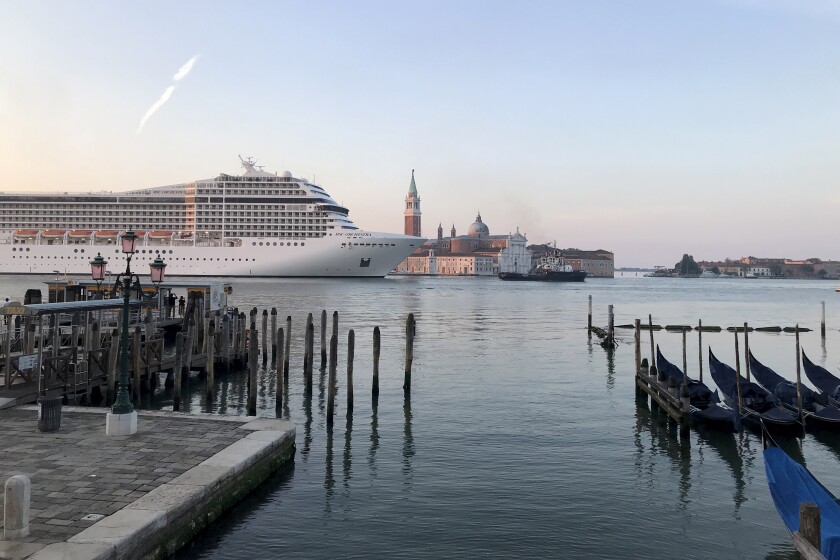 A cruise ship passes through Venice.