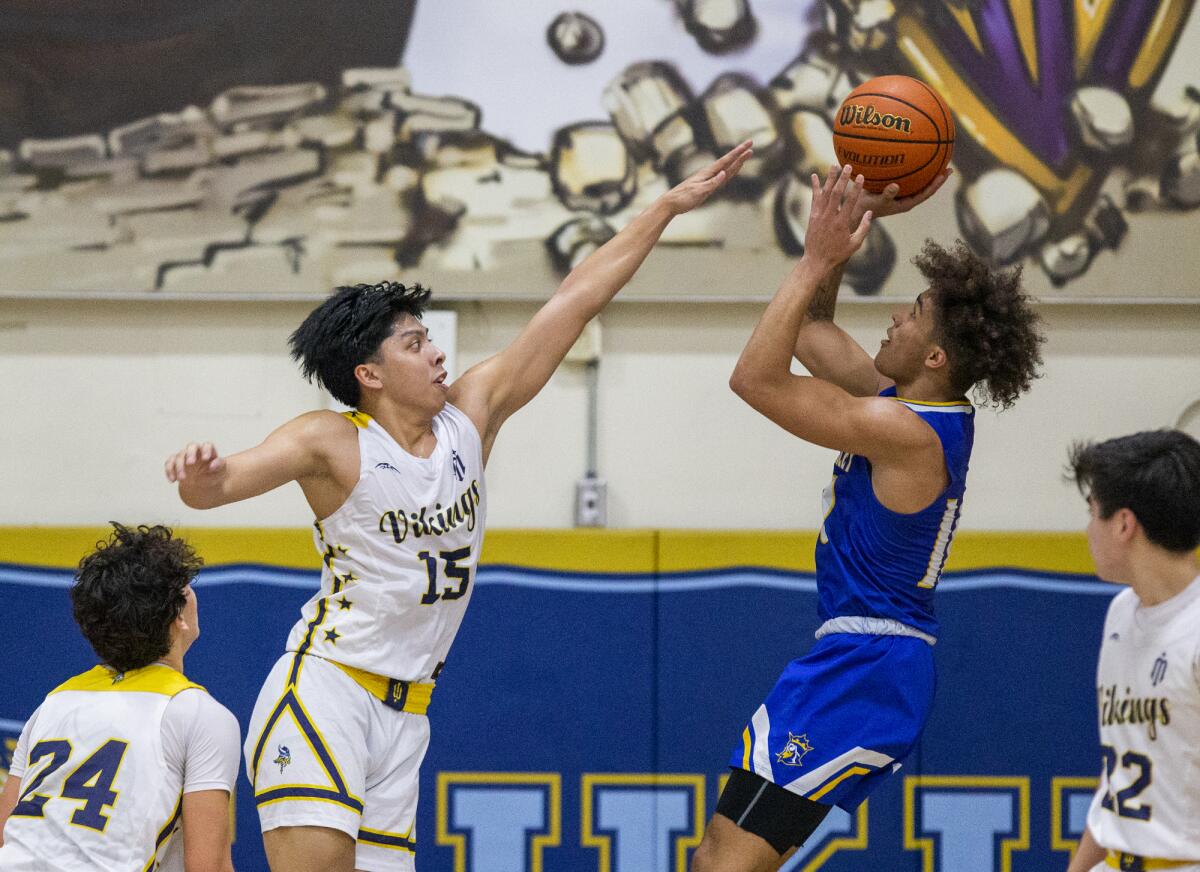 Marina's Kenji Duremdes attempts to block a shot from Fountain Valley's Roddie Anderson.