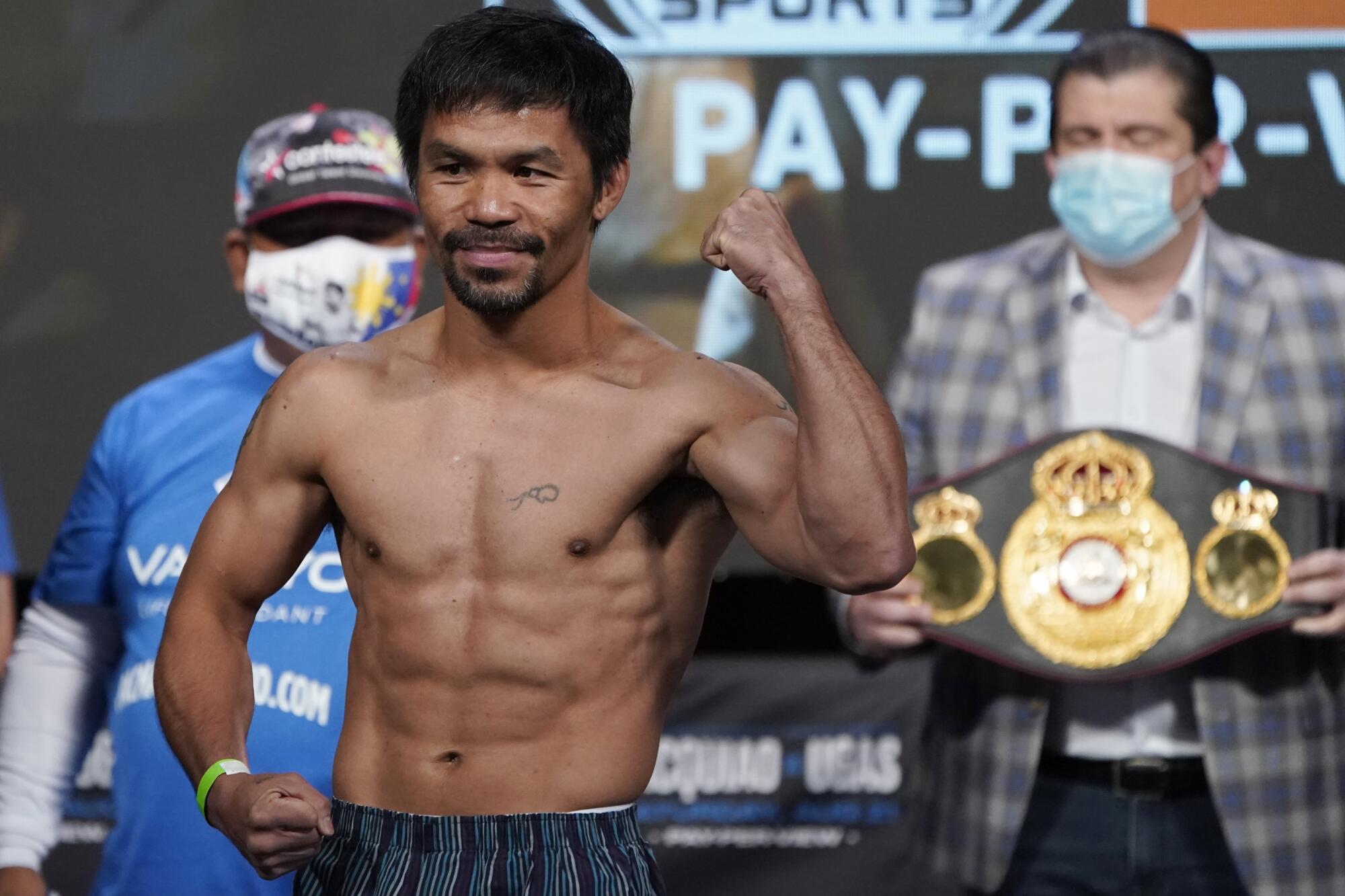 Manny Pacquiao, of the Philippines, poses for photographers during a weigh-in Friday, Aug. 20, 2021, in Las Vegas.