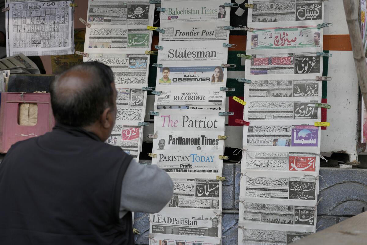 The morning newspapers in Pakistan featuring coverage of Iran's strike at a stall in Islamabad.