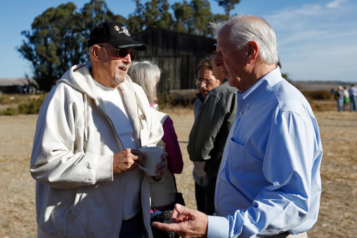 Congressman Mike Thompson (D-St. Helena), right, talks with Gordon Evans during a recent district visit. On Monday he convened a hearing on his proposal to close a loophole on background checks for gun buyers.