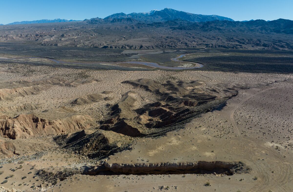 A river zigzags through a valley.