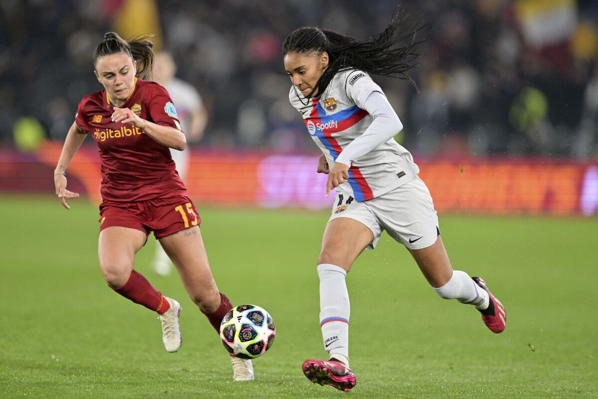 Barcelona's Salma Paralluelo, right, and Roma's Annamaria Serturini battle for the ball during the women's Champions League soccer match between Roma and Barcelona at Olimpic Stadium, Rome, Italy, Tuesday March 21, 2023. (Alfredo Falcone/LaPresse via AP)