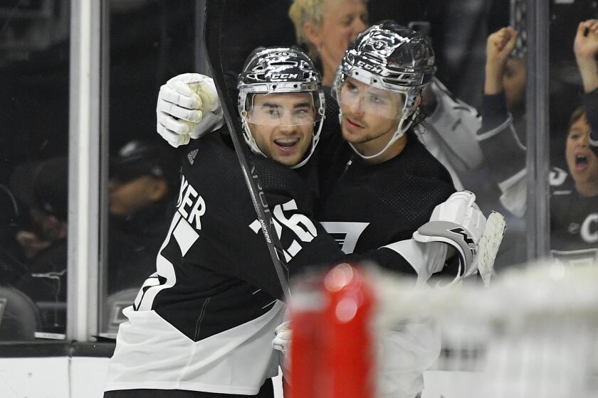 Los Angeles Kings center Adrian Kempe, right, celebrates his game-winning goal with defenseman Sean Walker during overtime in an NHL hockey game Saturday, Feb. 29, 2020, in Los Angeles. The kings won 2-1 in overtime. (AP Photo/Mark J. Terrill)