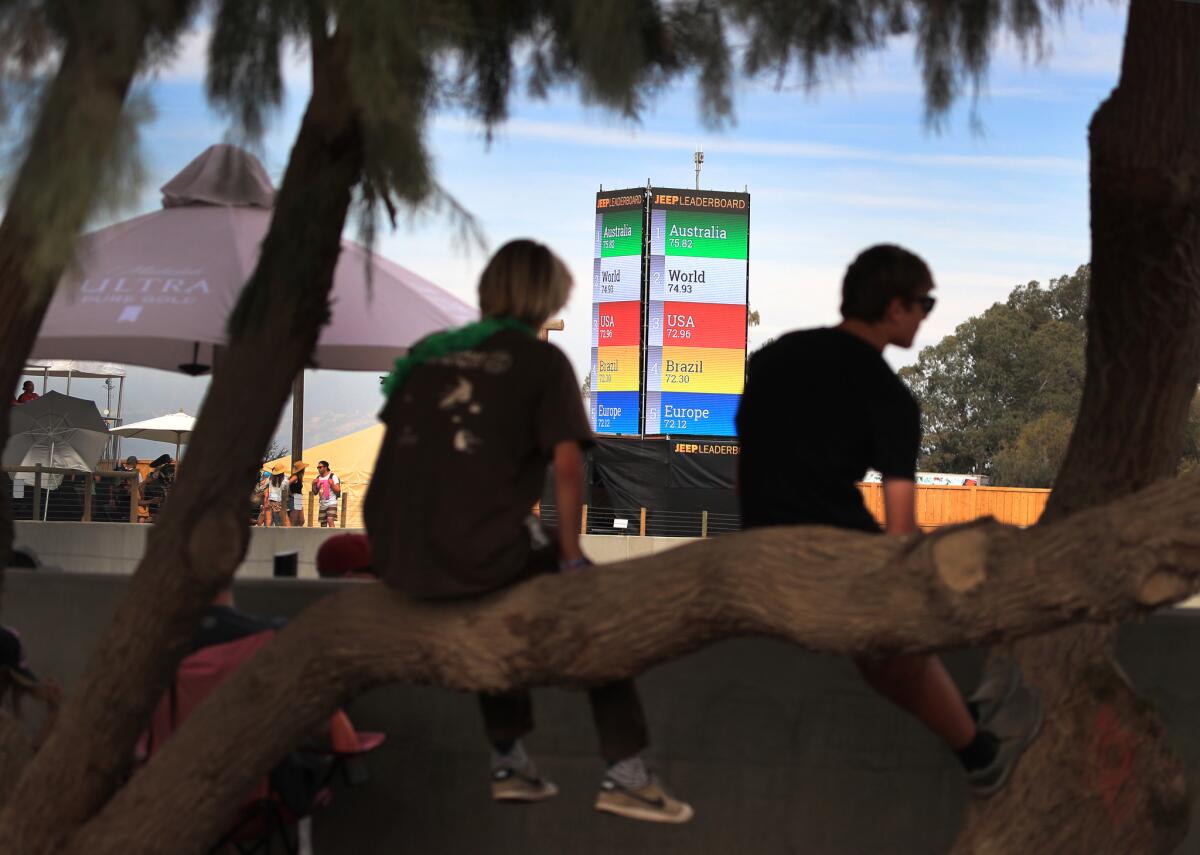 With a view of the team leader board, fans sit in trees and line the Surf Ranch pool to watch pro surfing come to rural California during the first-ever World Surf League Founder's Cup at Kelly Slater's Surf Ranch in Lemoore, CA.