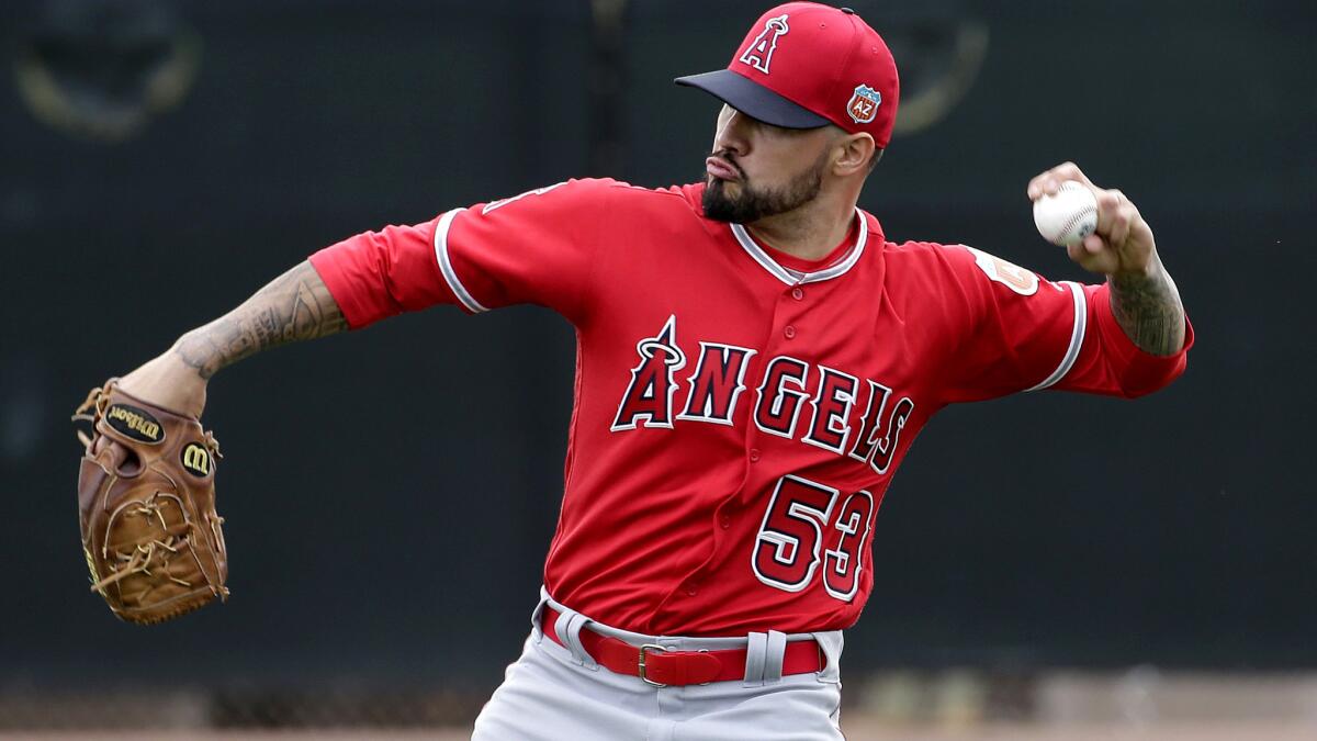 Angels starter Hector Santiago, shown during a spring training workout Feb. 19, pitched two scoreless innings in the team's exhibition opener on Wednesday.