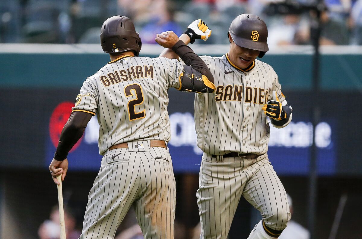 The Padres' Ha-Seong Kim, right, is congratulated by Trent Grisham (2) 
