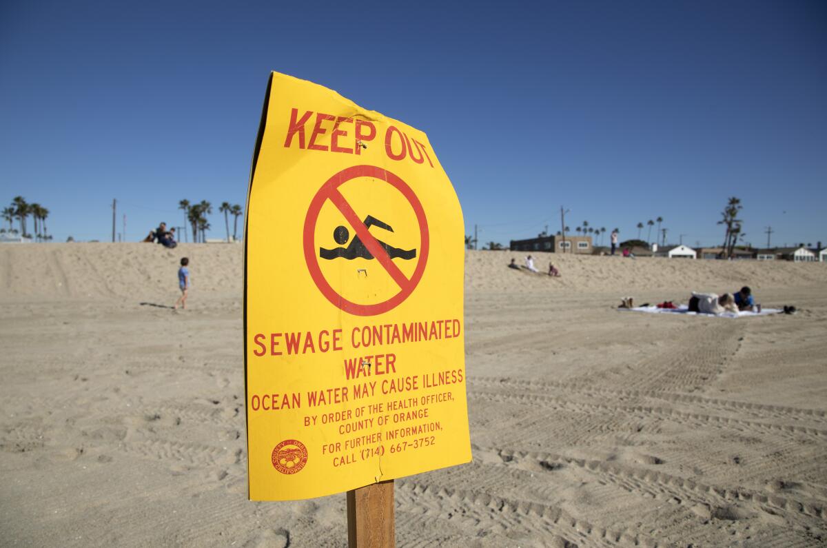 A "Keep out" sign on a beach.