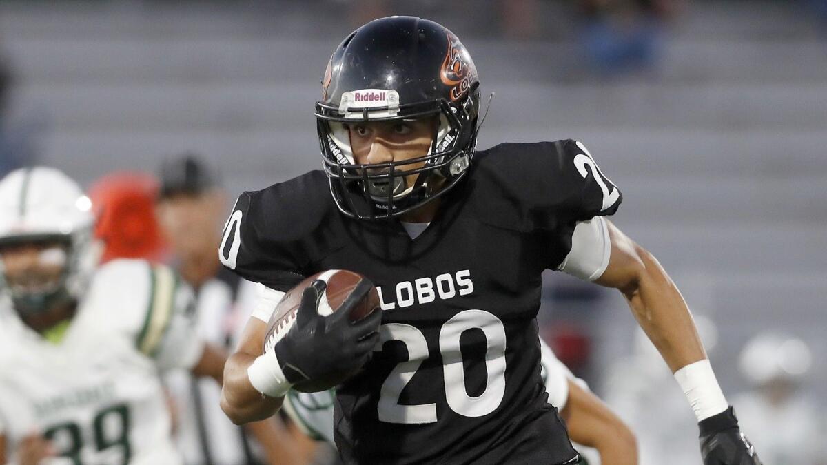 Los Amigos High wide receiver Adolfo Chavez produces one of his three touchdowns against Saddleback on Thursday. He had five catches for 108 yards.