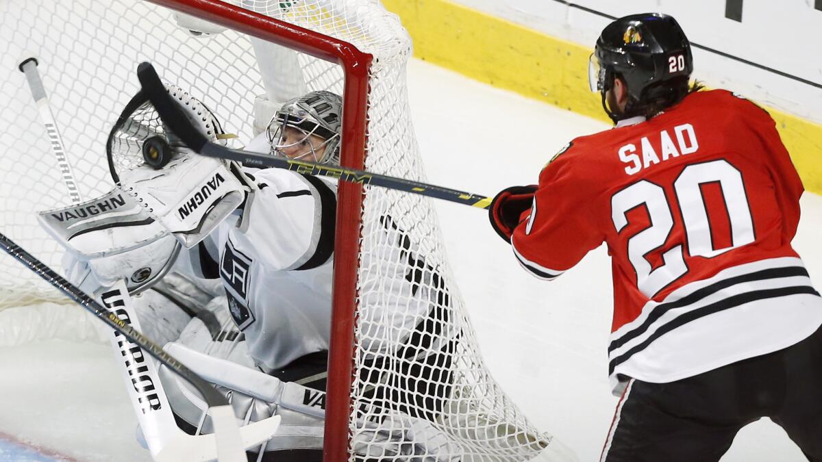 Kings goalie Jonathan Quick makes a save on a mid-air shot by Chicago Blackhawks left wing Brandon Saad during the second period of the Kings' 5-4 double-overtime loss in Game 5 of the Western Conference finals Wednesday.