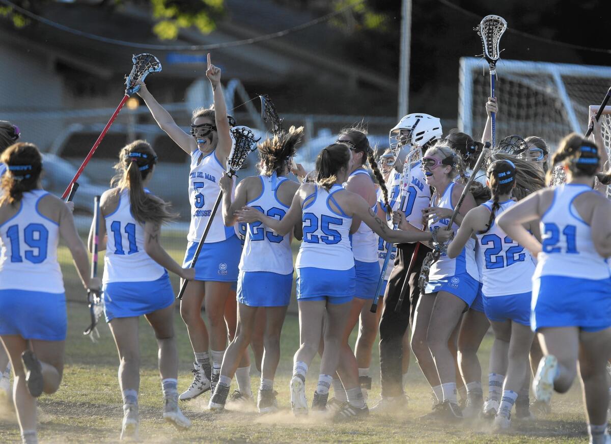 The Corona del Mar High girls' lacrosse team celebrates a victory over Newport Harbor in Saturday's Battle of the Bay game.