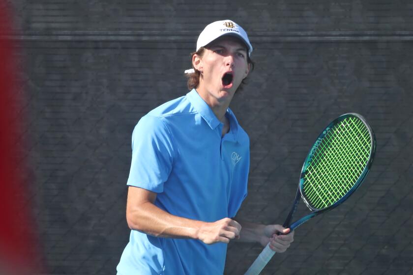 Number one rated double player Jonathan Hinkel reacts to putting away a volley between two opponents.