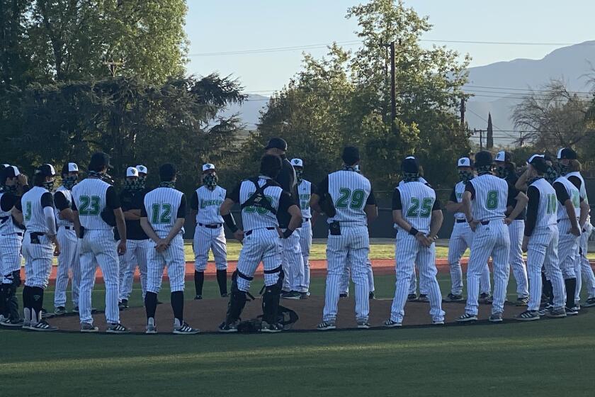 Thousand Oaks players receive a talk after hitting four home runs in 14-9 win over Westlake.