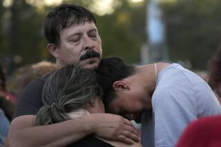 Daniel Delgado, top, is comforted by his 16-year-old son Angel Delgado, right, as he mourns the loss of his wife and Angel's mother, Monica Hernandez, who died at Impact Plastics during flooding caused by Hurricane Helene in Erwin, Tenn., on Thursday, Oct. 3, 2024. (AP Photo/Jeff Roberson)