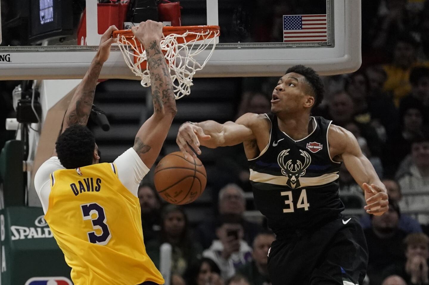 Anthony Davis dunks the ball in front of Giannis Antetokounmpo during the second half of a game Dec. 19.