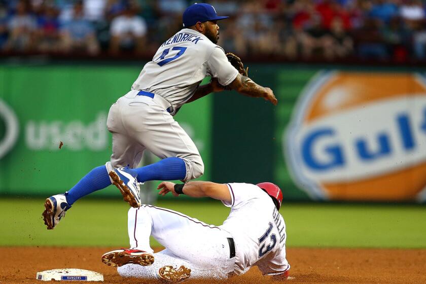 Dodgers' Howie Kendrick turns a double play over Rangers' Joey Gallo in the fourth inning on Tuesday.