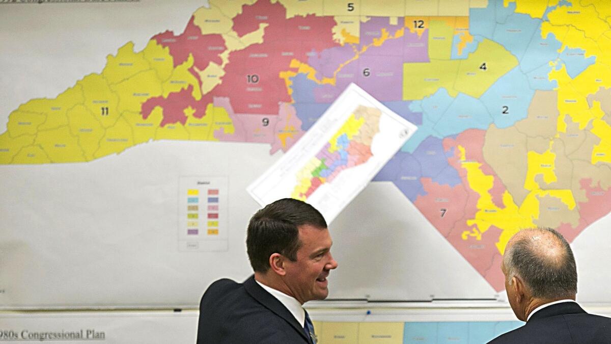 Republican state Sens. Dan Soucek, left, and Brent Jackson review maps of congressional districts during a special session of the North Carolina General Assembly in Raleigh in 2017.