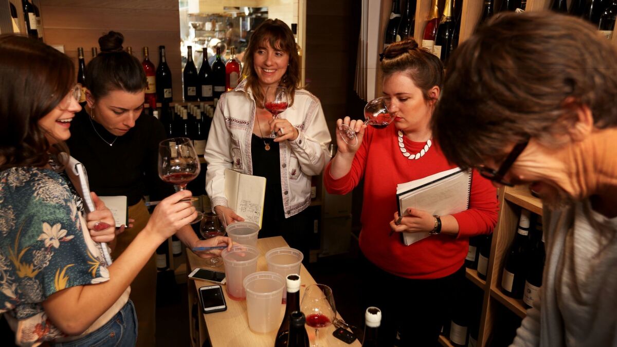 Helen Johannesen, center, and her employees Bethany Kocak, left, Molly Kelly and Heather Newman as they test wine brought in by Robert Brownson of Farm Wine Imports.