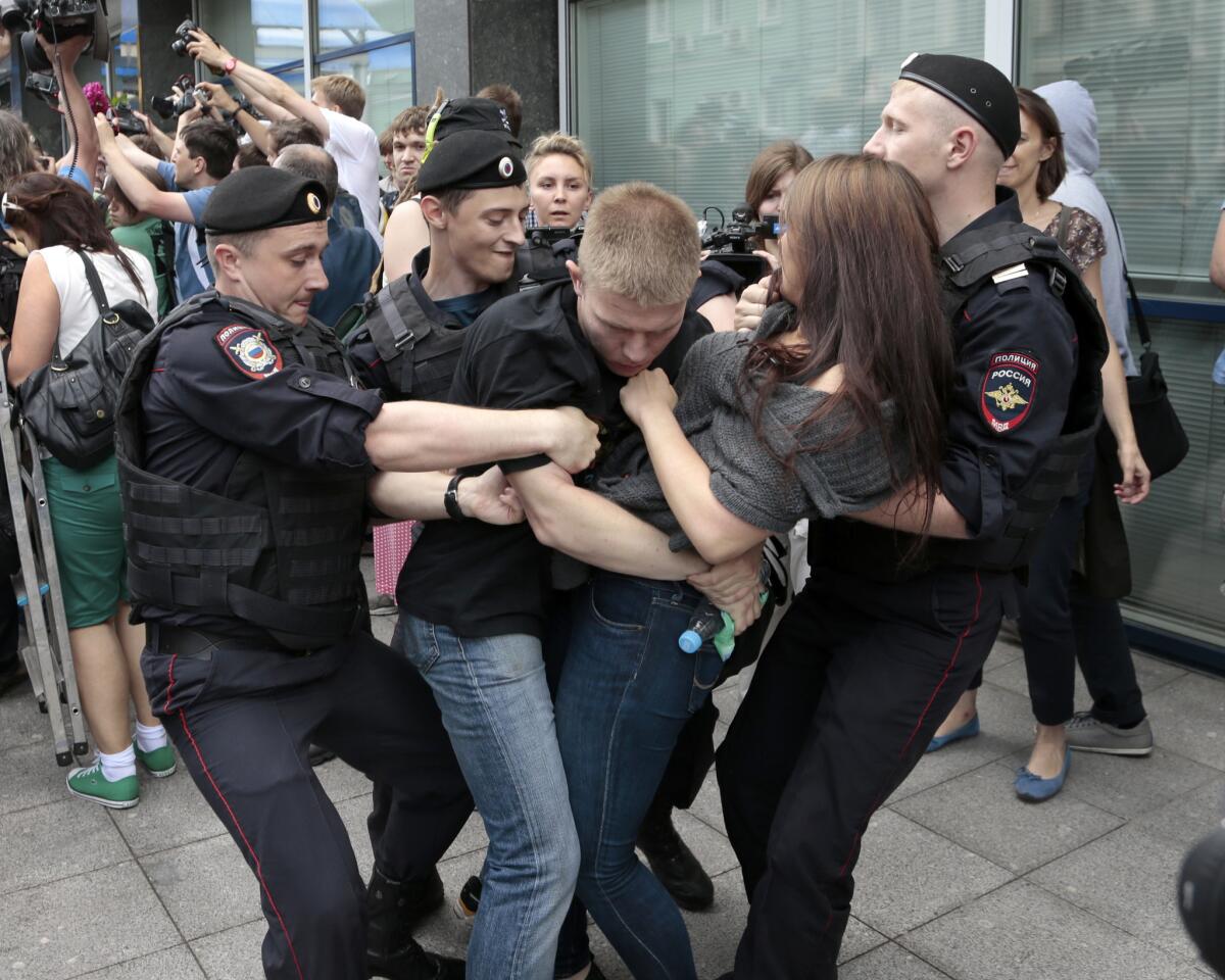 Police officers detain gay rights activists as they gathered near Russia's lower parliament chamber last week to protest a bill to ban teaching children about homosexuality.