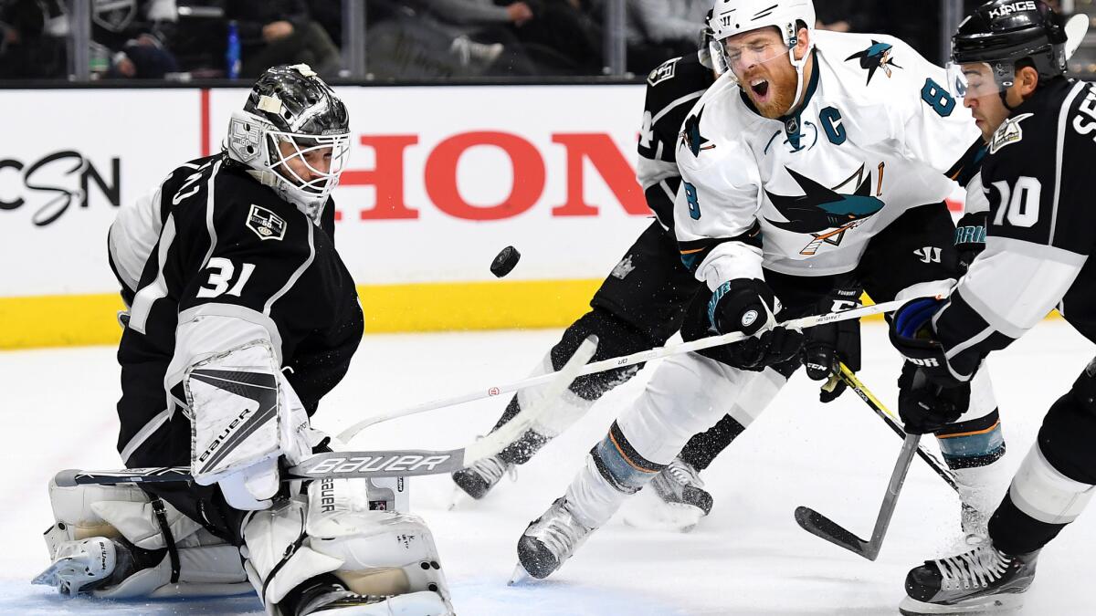 Kings goalie Peter Budaj makes a save against Sharks captain Joe Pavelski during the second period Wednesday night at the Staples Center.
