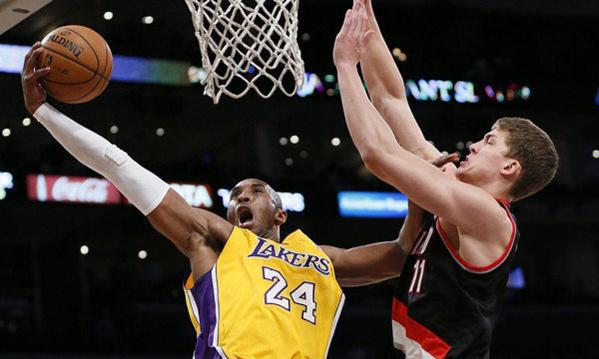 Lakers guard Kobe Bryant attempts a layup in front of Portland big man Meyers Leonard.