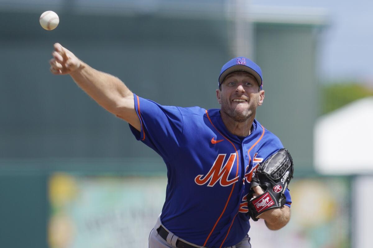 New York Mets' Max Scherzer pitches in the second inning of a spring training baseball game against the Miami Marlins, Monday, March 21, 2022, in Jupiter, Fl. (AP Photo/Sue Ogrocki)