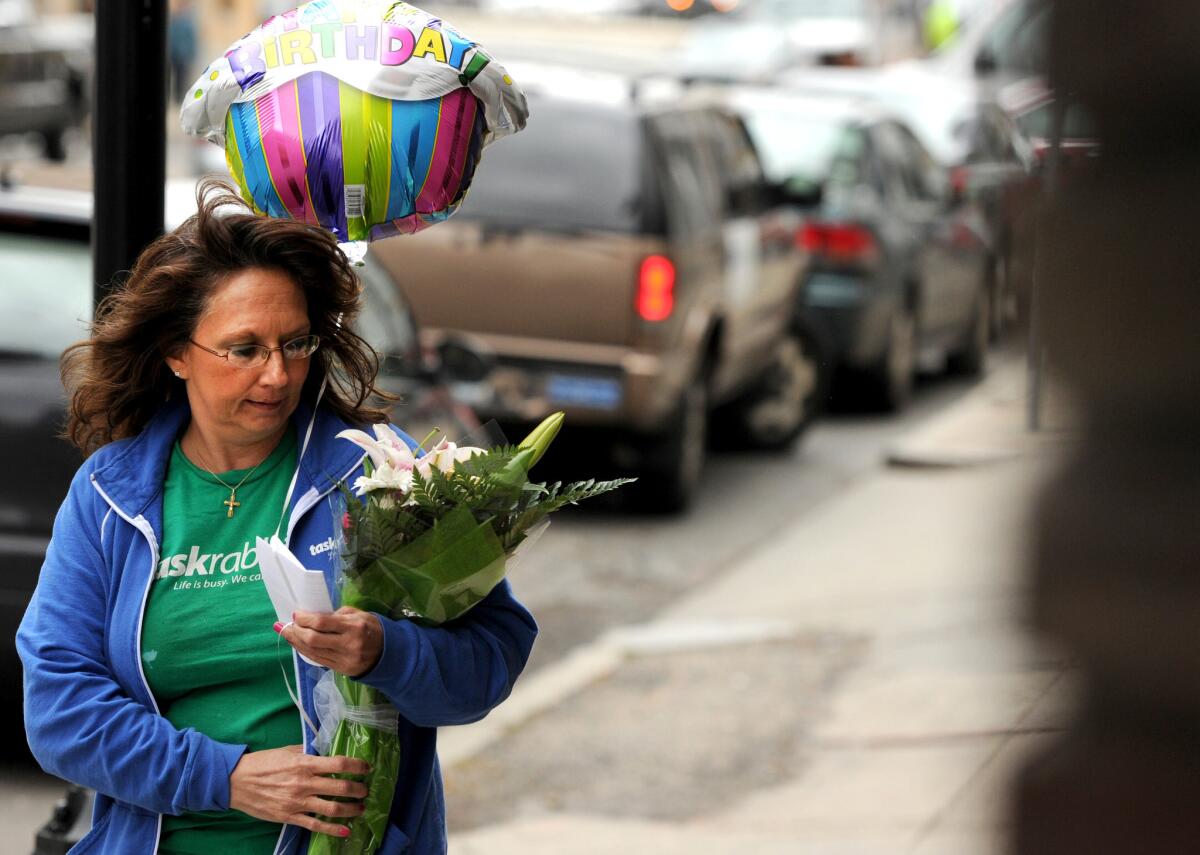 Diane Hohen, with TaskRabbit, delivers a bouquet of flowers in Boston in 2012.