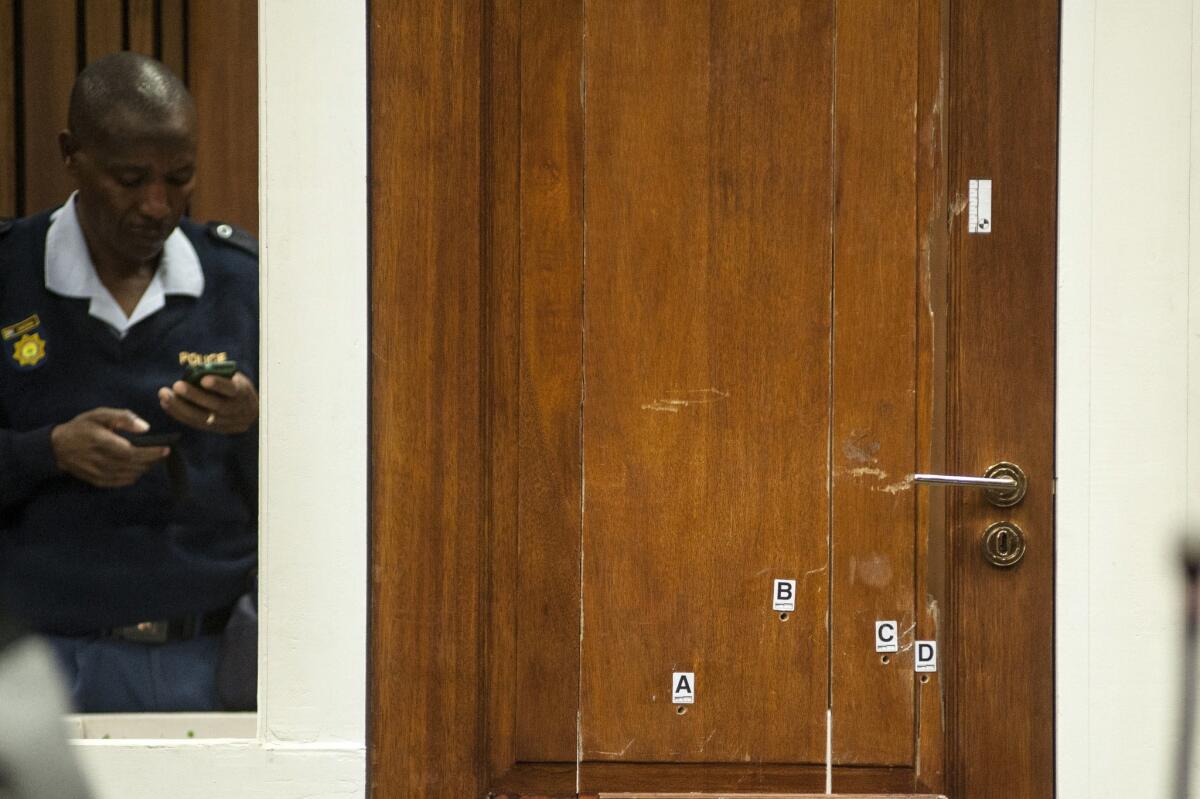 The bathroom door of South African paralympic athlete Oscar Pistorius with the bullet holes is put on display in the courtroom during his murder trial in Pretoria, South Africa, on June 30. Pistorius has sold the home where the shooting took place.