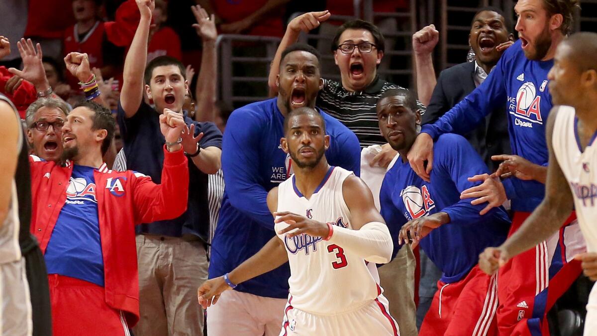 The Clippers bench erupts in celebration after point guard Chris Paul, center, scores the winning basket with one second remaining in Game 7 of the Western Conference quarterfinals against the San Antonio Spurs on Saturday.