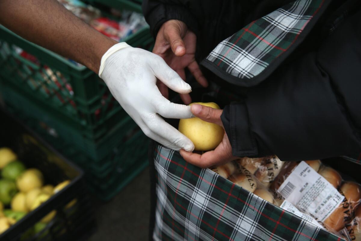Brooklyn residents receive free food as part of a Bowery Mission outreach program in New York City. Wealth inequality in the U.S. surged during the housing downturn for the first time since the 1980s, a new report finds.