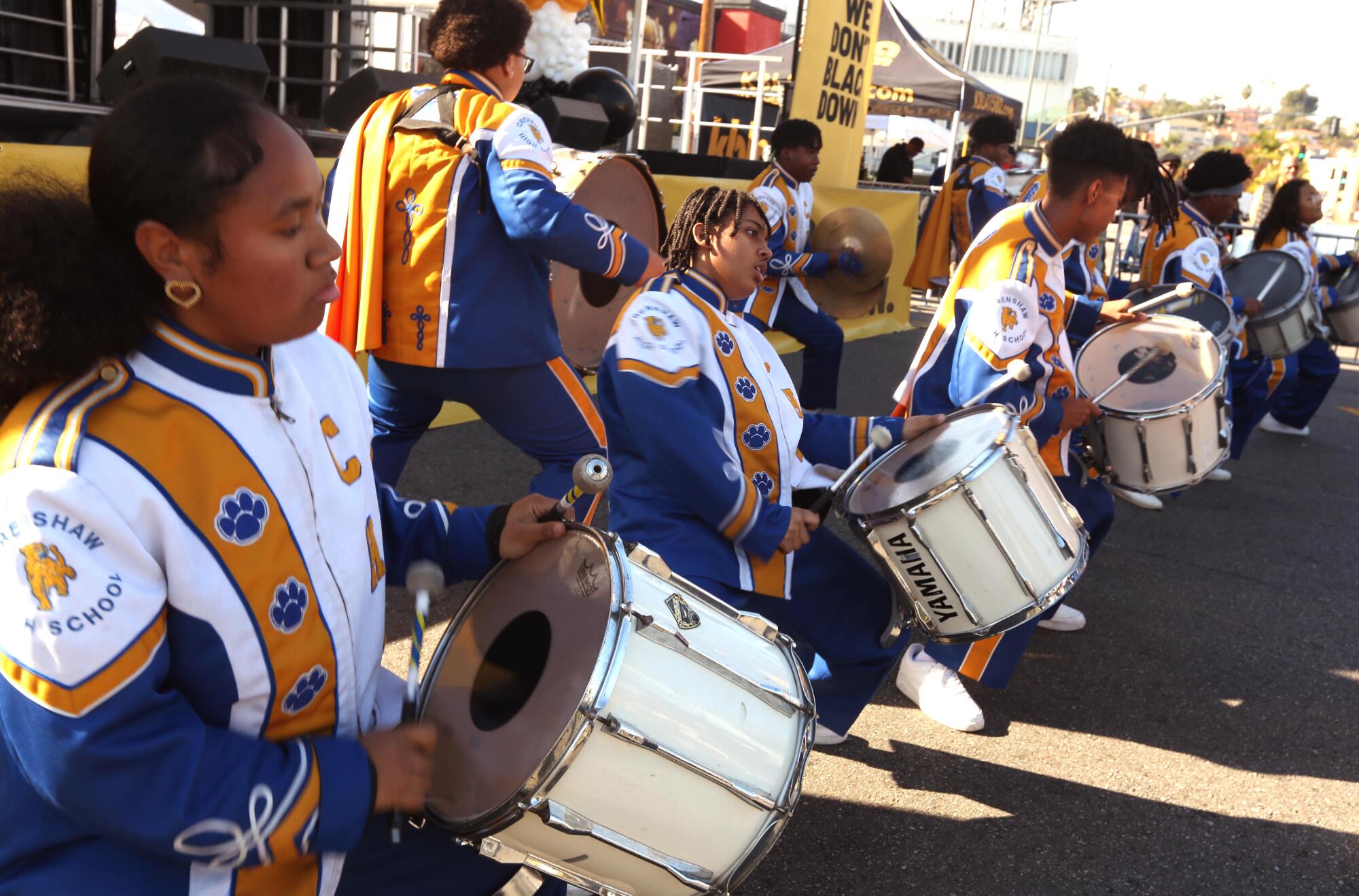 Members of the Crenshaw High School Marching Band perform at the KBLA 1580 Talk Radio "homecoming" event 
