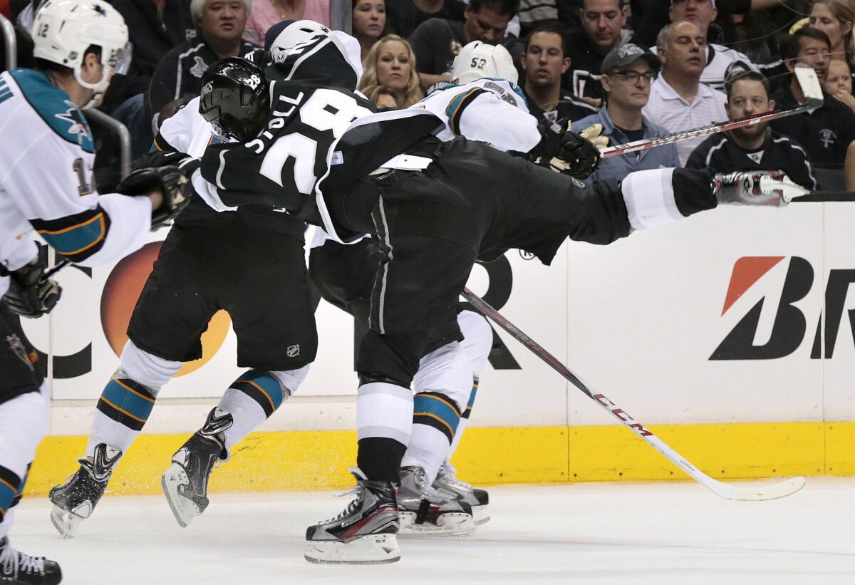 Kings' Jarret Stoll gets knocked to the ice by the San Jose Sharks' Raffi Torres in Game 1 of the Western Conference semifinals.