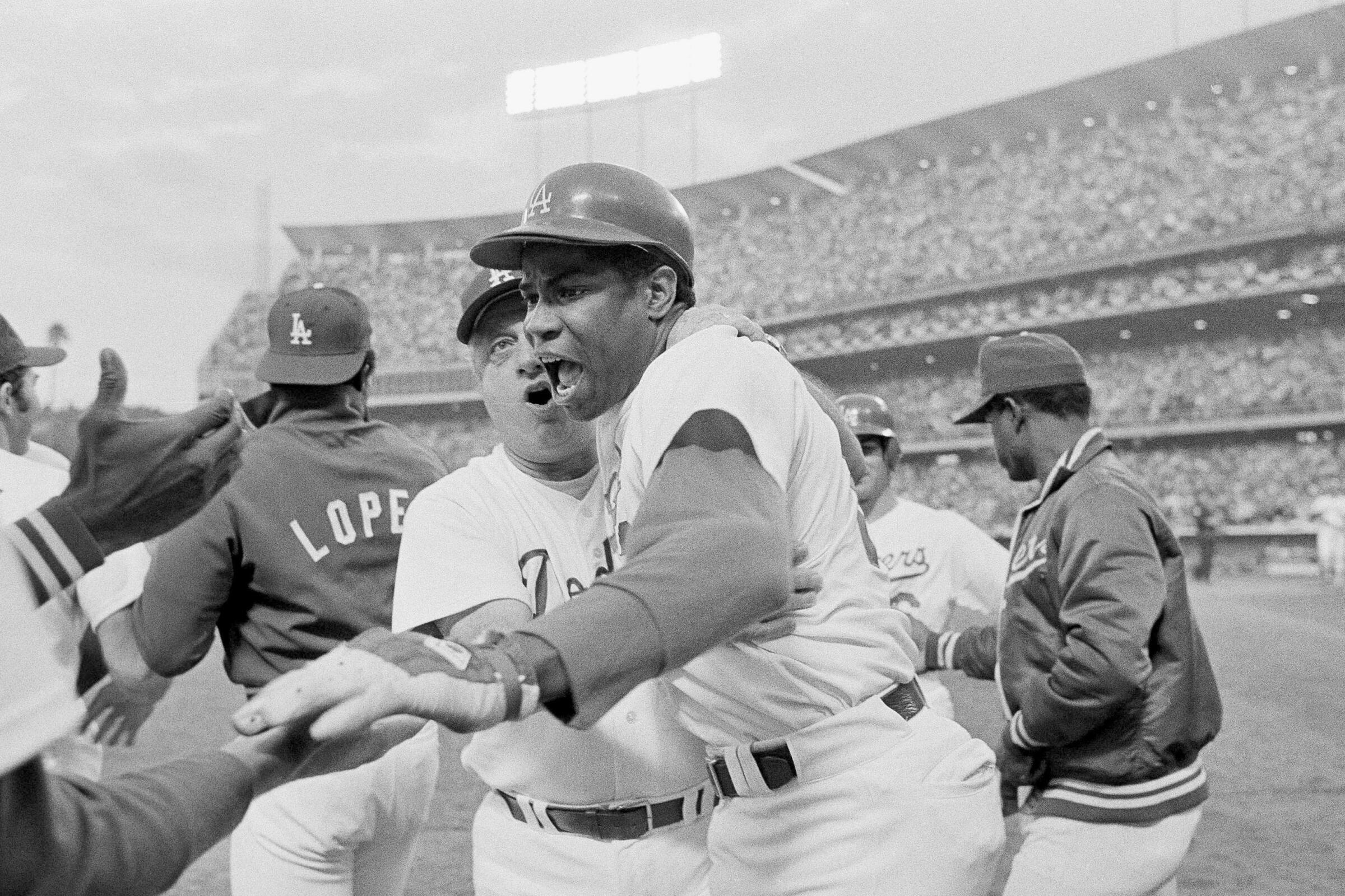 Dusty Baker celebrates with manager Tommy Lasorda and his Dodgers teammates after homering in Game 2 of the 1977 NLCS.