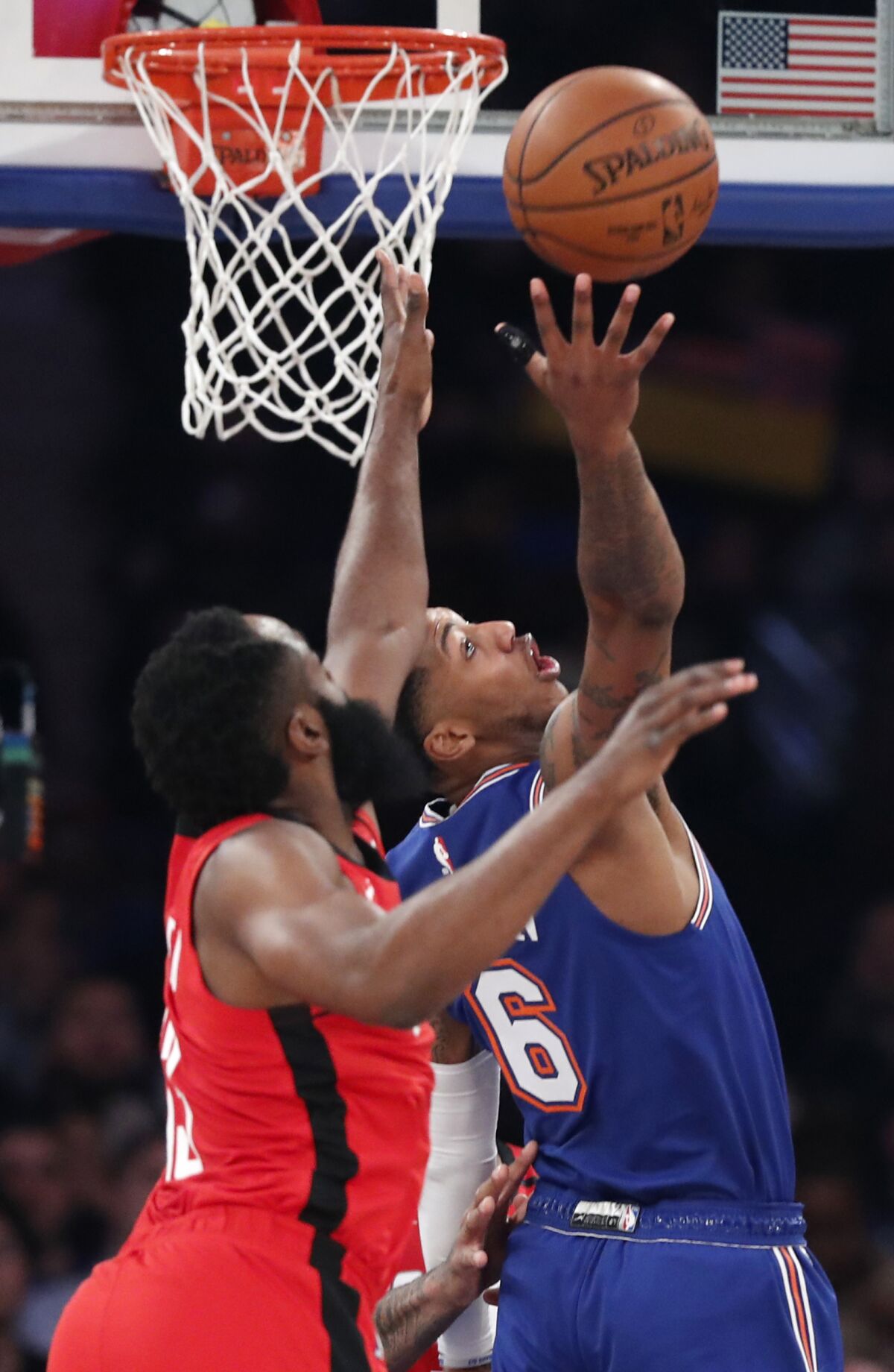 Houston Rockets guard James Harden, left, pressures New York Knicks guard Elfrid Payton (6) during the first quarter of an NBA basketball game in New York, Monday, March 2, 2020. (AP Photo/Kathy Willens)
