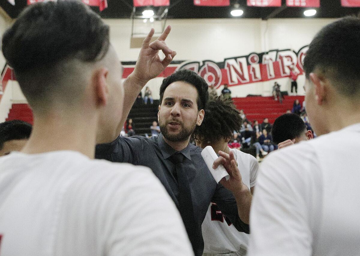 Glendale's head coach Ib Belou enthusiastically talks with his team during a timeout against Salesian in the CIF Southern Section division III-AAA second-round boys' basketball playoff in at Glendale High School on Friday, February 14, 2020. Salesian won the game in overtime beating Glendale 55-49.