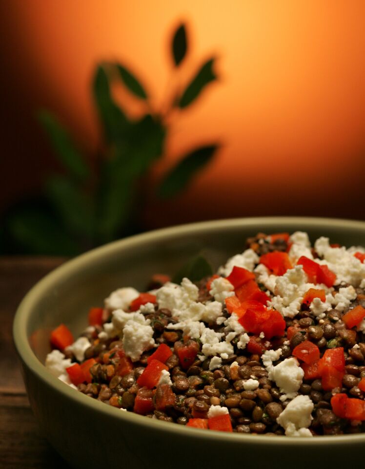 Lentils, colorful vegetables and rich feta are tossed in a tangy lemon vinaigrette.
