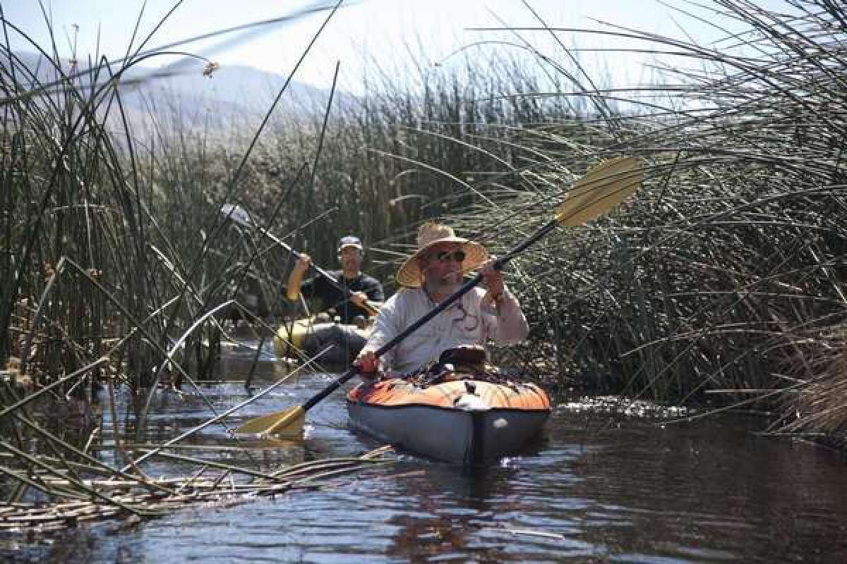 Owens Valley environmentalist Mike Prather and Inyo County projects manager navigate the Lower Owens River in kayaks.