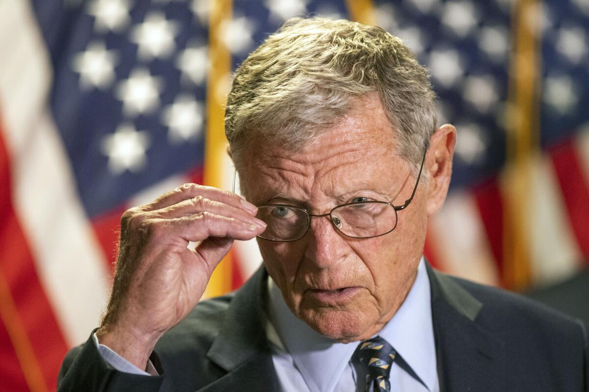 Sen. James Inhofe, wearing glasses in front of an American flag background