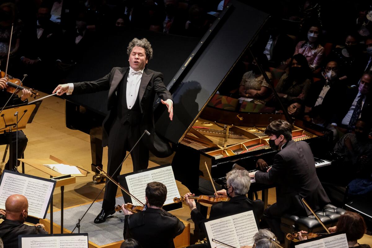 Gustavo Dudamel passionately gestures toward the violin section from the podium.