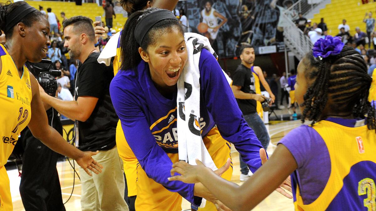 Sparks forward Candace Parker greets her daughter, Lailaa Nicole Williams, at mid-court after scoring 30 points in a victory over the Sky on Wednesday.