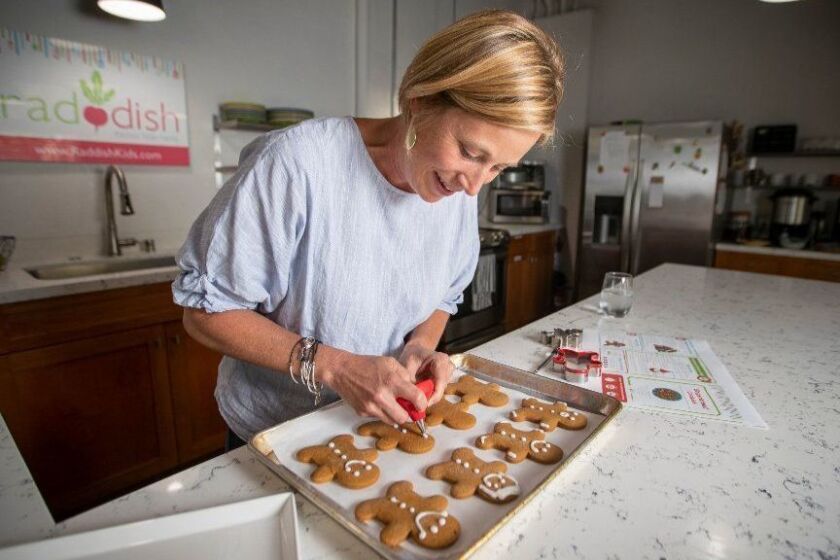 REDONDO BEACH, CALIF. -- WEDNESDAY, JULY 10, 2019: LA-based Samantha Barnes, founder and CEO of Raddish makes gingerbread cookies in her test kitchen at Raddish in Redondo Beach. Raddish is a monthly kit that comes to children's mailboxes that teaches culinary skills and how to make recipes that may be new, old or foreign to them, Raddish also teaches the scientific processes, history, culture, nutritional benefits behind the foods we eat. Barnes began her working career as a school teacher before she found her passion: helping children learn how to shop, cook and bring families closer together. Photo taken in Redondo Beach, Calif., on July 10, 2019. (Allen J. Schaben / Los Angeles Times)