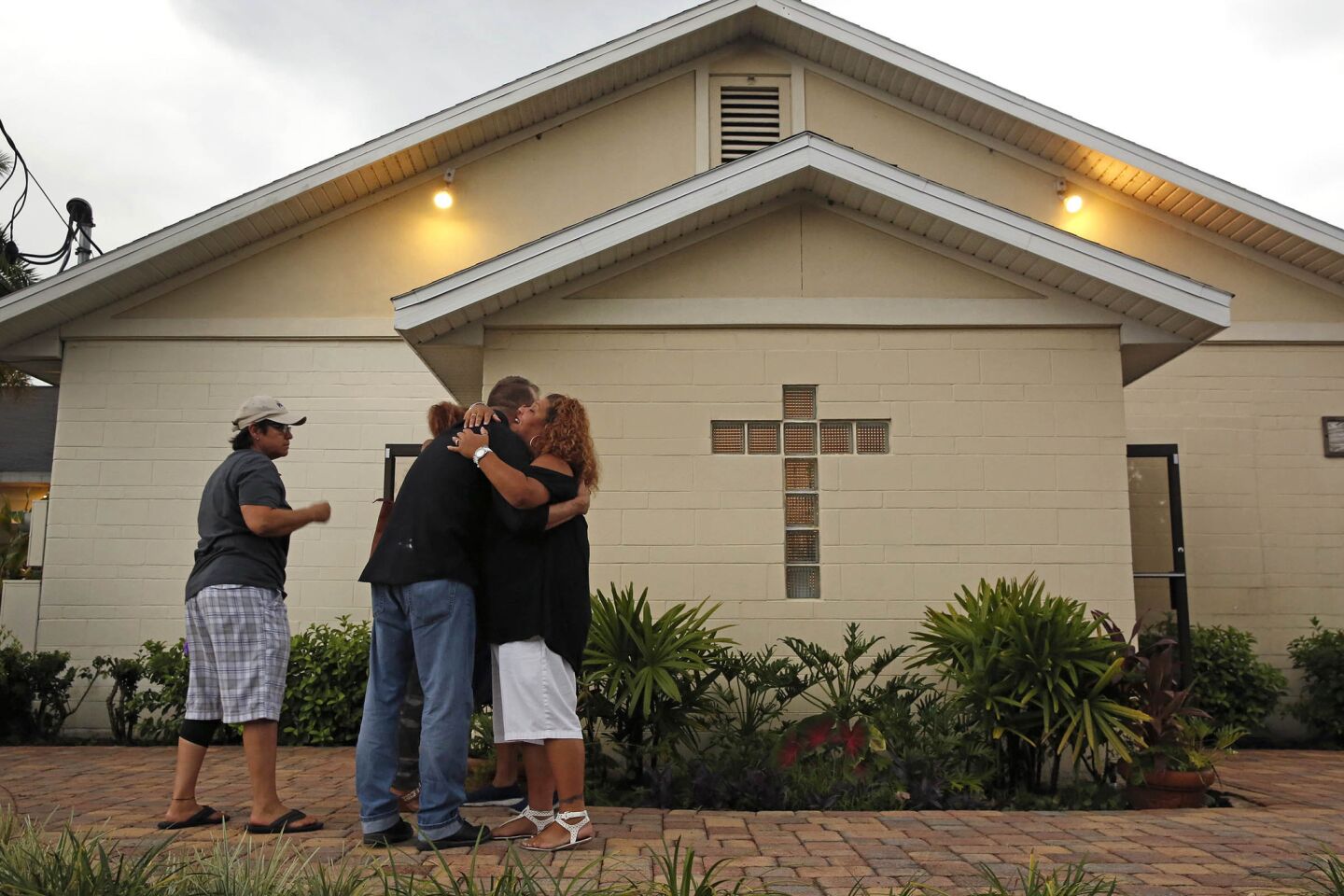 People hug in solaceafter a vigil and church service held at Joy Meropolitan Community Church very close to Pulse nightclub.