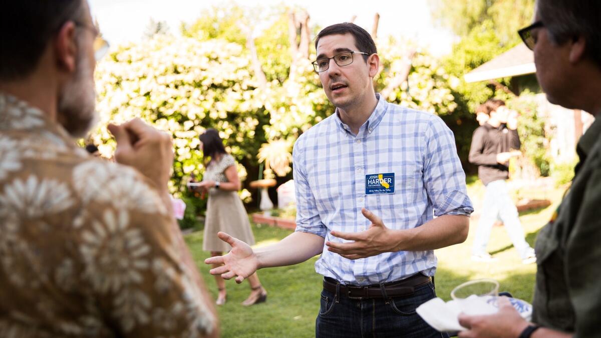 Democratic congressional candidate Josh Harder speaks with voters during a campaign event at a home in Modesto.